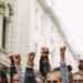 Arms raised in protest. Group of protestors fists raised up in the air.