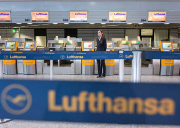 FRANKFURT AM MAIN, GERMANY - DECEMBER 01:  An employee of the German airline Lufthasa wait for empty Lufthansa counter at Frankfurt International Airport during a strike by Lufthansa pilots on December 1, 2014 in Frankfurt, Germany. The pilots are demanding that Lufthansa keep the current retirement policy that allows pilots to retire at 55. Today's strike affects short and medium-distance flights today and will widen to affect long-distance flights tomorrow. According to Lufthansa the strike will lead to the cancellation of 1,350 flights and affect 150,000 passengers.  (Photo by Thomas Lohnes/Getty Images)