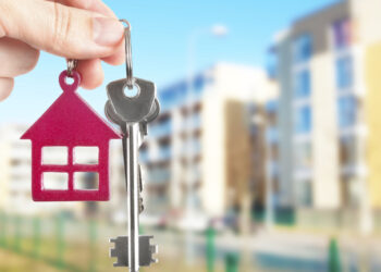 Handing keys in the house background