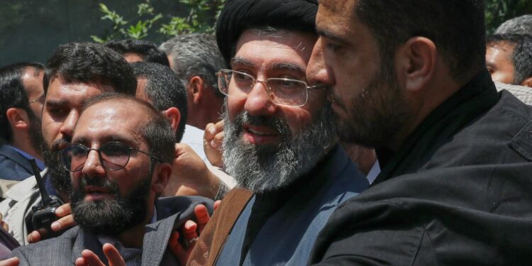 Mojtaba Khamenei, the son of Iran's Supreme Leader, Ayatollah Ali Khamenei, center, attends the annual Quds, or Jerusalem Day, rally in Tehran, Iran, May 31, 2019. (AP Photo/Vahid Salemi)