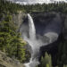 Helmcken Falls, one of Canada’s most spectacular waterfalls, cascades 141 meters (463 feet) down rugged volcanic rock in the heart of Wells Gray Provincial Park, British Columbia. This dramatic scene captures the sheer power and beauty of the waterfall, with mist rising from the plunge pool and sunlight illuminating the rugged canyon walls.